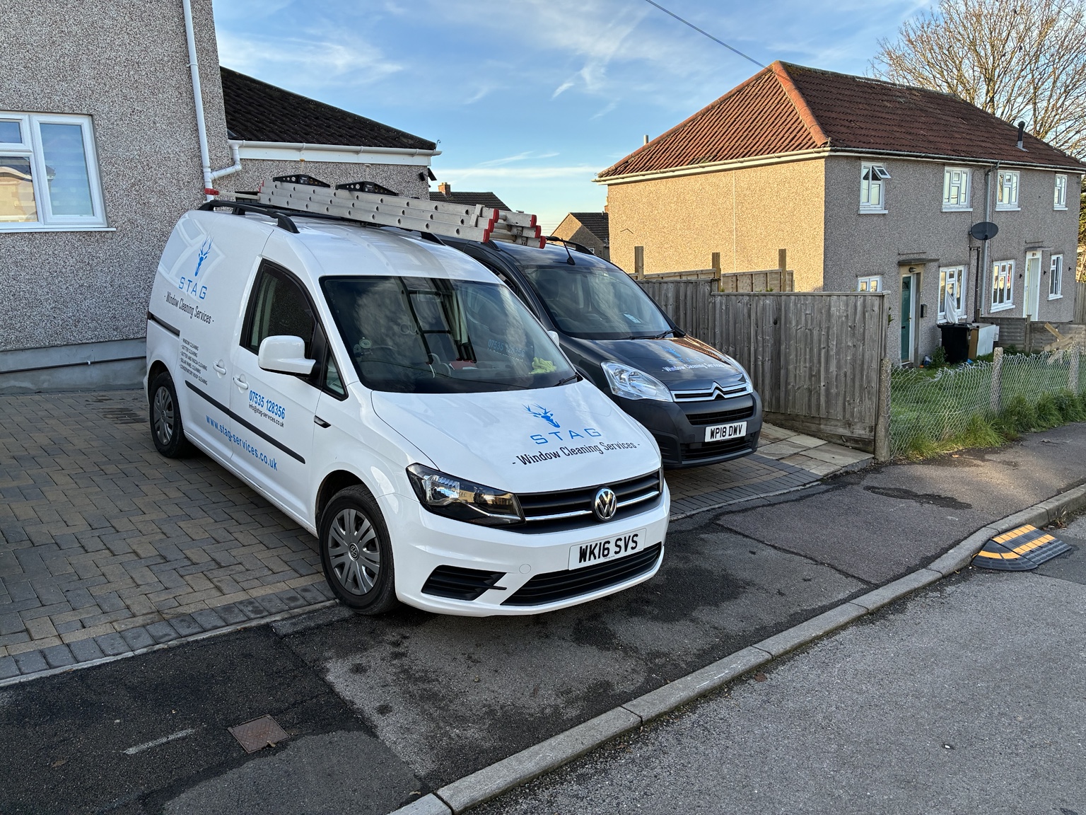 Two Stag Window Cleaning Services vans parked locally